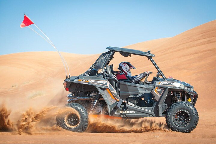 Experience the rush of racing through Dubai's sand dunes in a powerful Polaris buggy surrounded by stunning desert landscapes. Adventure and excitement await every traveler seeking action.